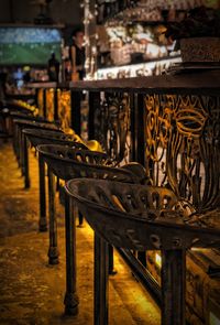 Empty chairs and table in restaurant against building