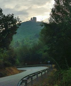 Road by bridge against sky