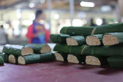 Close-up of food wrapped in banana leaves on table