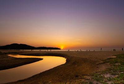 Scenic view of beach against sky during sunset