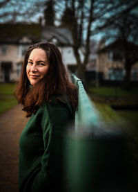 Portrait of woman standing against wall 