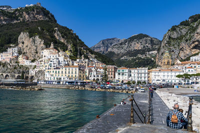 Scenic view of sea by town against sky