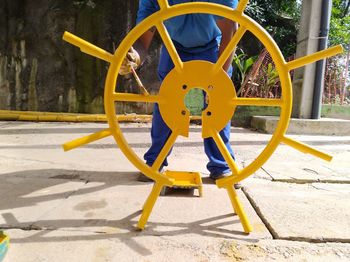 Yellow playground against blue sky on sunny day
