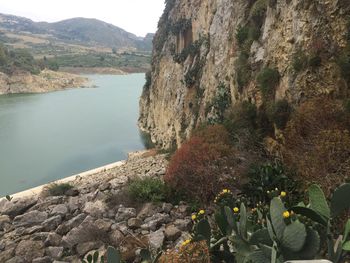 Scenic view of sea by mountain