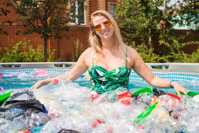 Portrait of smiling young woman in swimming pool