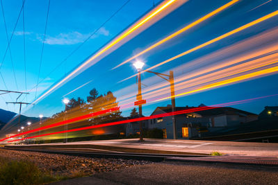 Light trails on road against sky in city