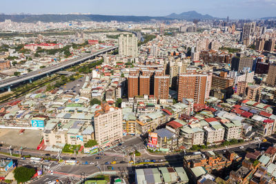 High angle view of modern buildings in city against sky