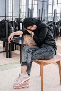 Low section of woman sitting on chair