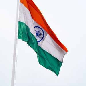 India flag flying high at connaught place with pride in blue sky, india flag fluttering, indian flag