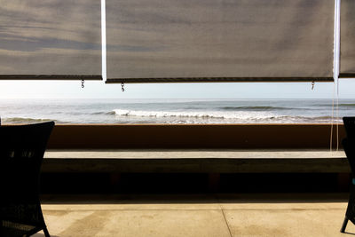 Rear view of woman sitting on bench