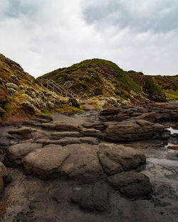 Rock formation on land against sky