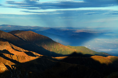 Scenic view of mountains against cloudy sky