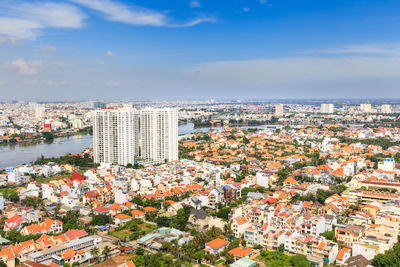 High angle view of buildings in city against sky on sunny day