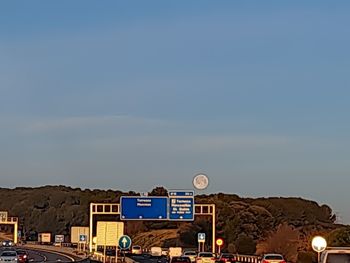 Cars on road against sky