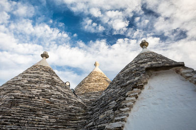 Low angle view of building against cloudy sky