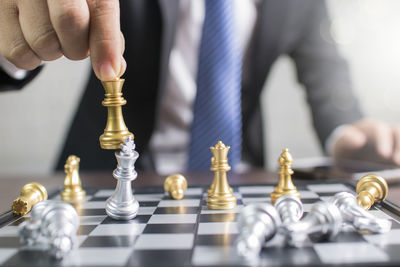 Close-up midsection of businessman playing chess