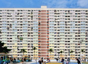 Group of people against buildings in city