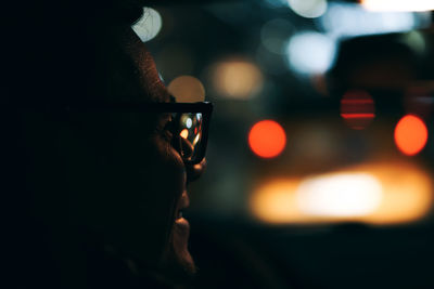 Close-up of man in car at night