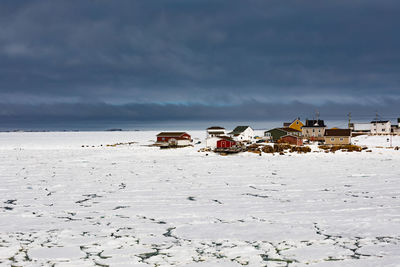 View of snow covered land against sky