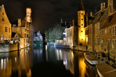 Canal passing through city buildings at night