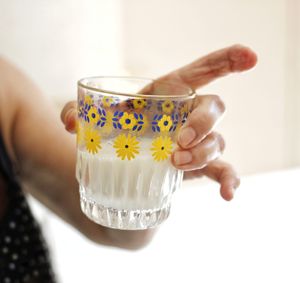 Close-up of hand holding tea cup