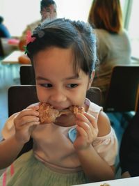 Portrait of girl eating food