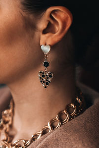 Close-up of woman holding pearl jewelry