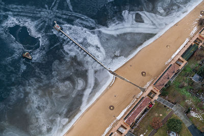 High angle view of wet road by sea