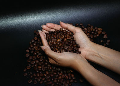 High angle view of hand holding coffee cup