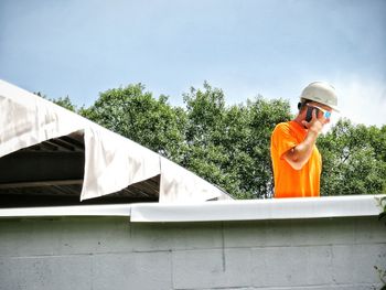 Man standing against orange wall