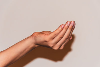 Close-up of hands over white background