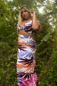 Beautiful young woman standing on land