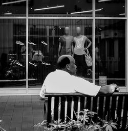 Rear view of women sitting on chair