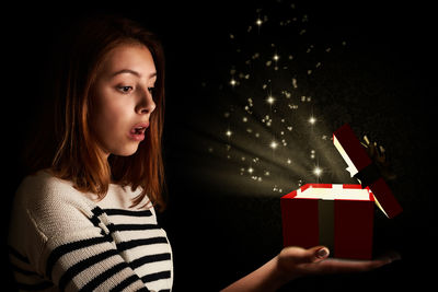 Woman holding christmas tree in box