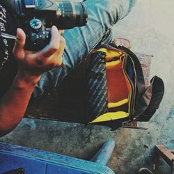 Low section of man photographing car