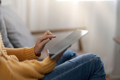 Midsection of woman using mobile phone