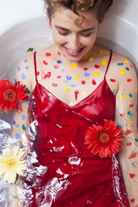 High angle view of woman with painted body lying in bathtub