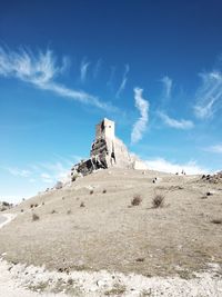 Low angle view of castle on mountain against sky