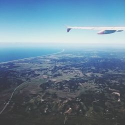 Aerial view of airplane flying over landscape