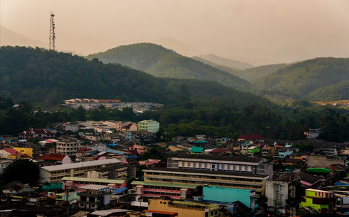 High angle view of townscape and mountains against sky