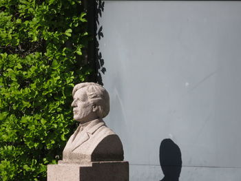 Statue against trees and plants