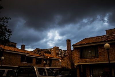 Low angle view of building against cloudy sky