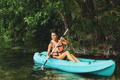 Woman kayaking in lake