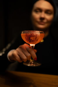 Midsection of woman holding wineglass