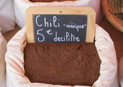 Close-up of price tag in chili powder sack at market