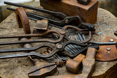 Close-up of rusty hand tools on tree stump