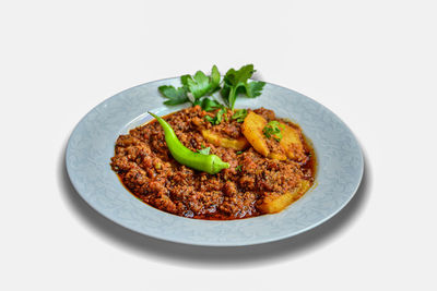 High angle view of food in plate on white background