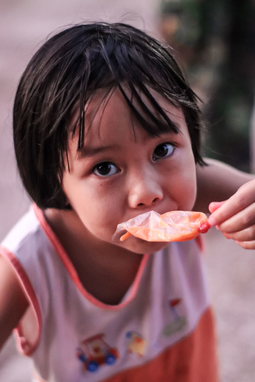 child, childhood, eating, food, portrait, food and drink, person, skin, one person, looking at camera, holding, baby, hungry, toddler, human face, female, sweetness, nose, men, innocence, cute, biting, front view, sweet food, human mouth, headshot, casual clothing, smiling, healthy eating, women, sweet, emotion, fast food, frozen food, snack, teenager, wellbeing, dairy, meal, happiness, fruit, lifestyles, human head, human eye, day, enjoyment