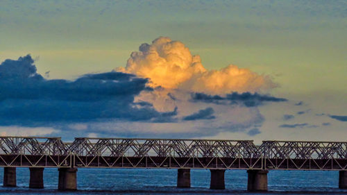 Low angle view of bridge over sea against sky