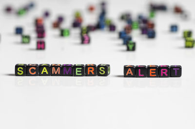 Close-up of toys on table against white background